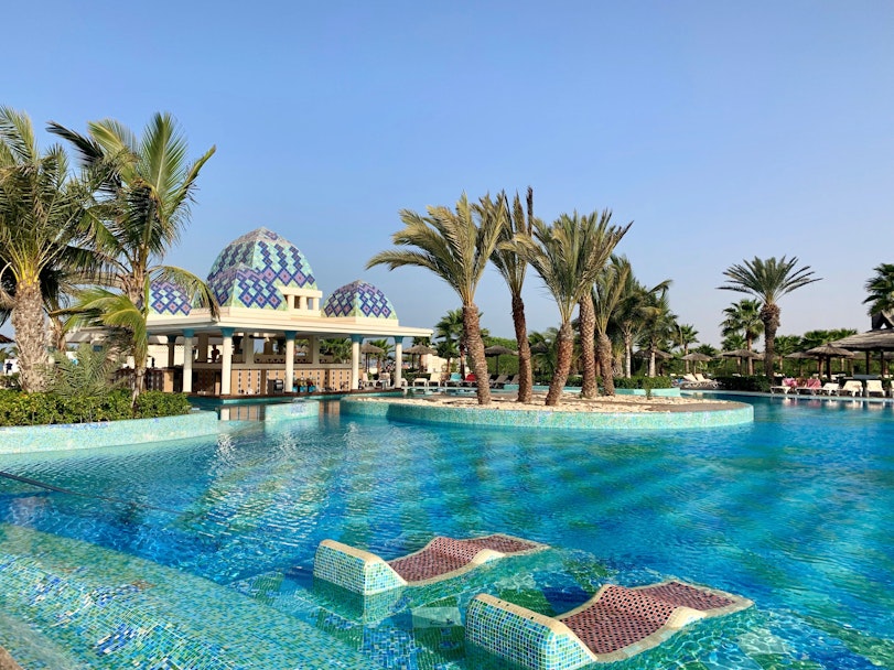 Zwembad van RIU Karamboa met waterligbedden en tropische palmbomen